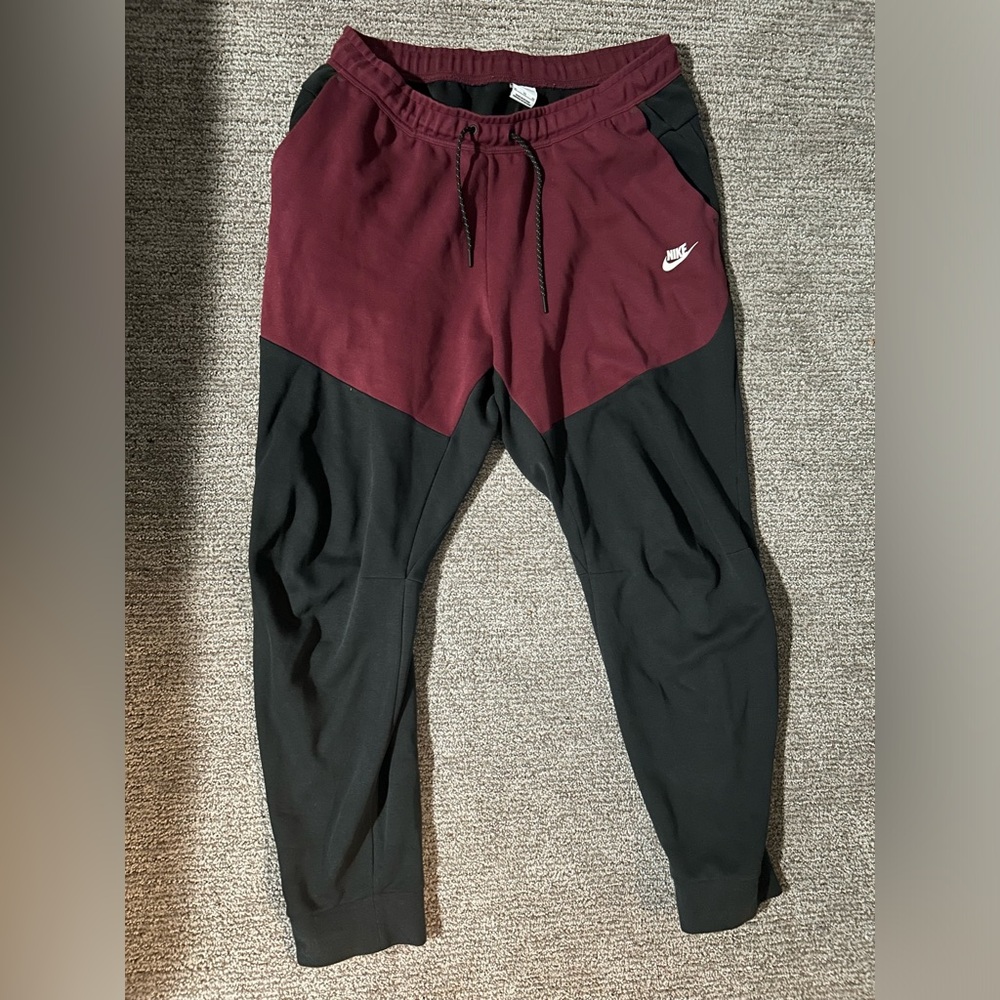 Red and black Nike tech pants